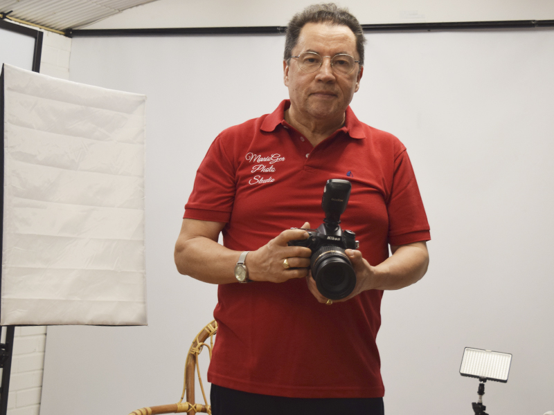 MarioGer Photo Studio CEO, German posing with his professional camera.